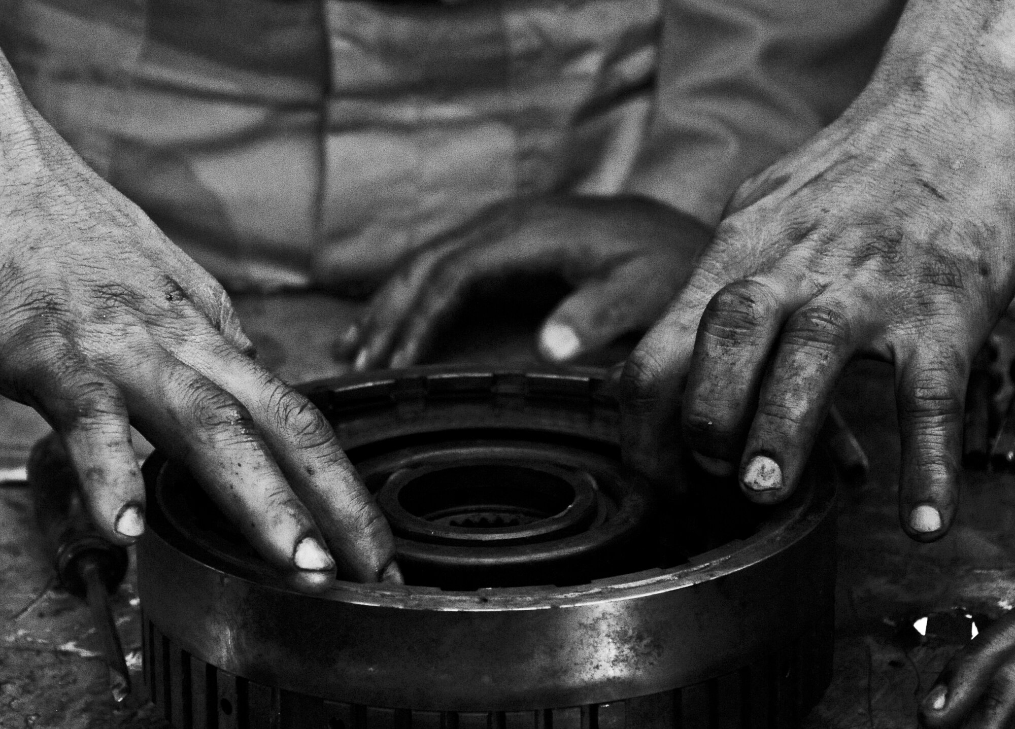 The hands of an Iraqi Army vehicle maintenance technician disassembles a component of an Allison transmission during a transmission training course hosted by the Logistics Military Advisory Team at Camp Ur, Iraq Mar. 22, 2010.  (U.S. Air Force photo by Staff Sgt. Miguel Lara III/released)