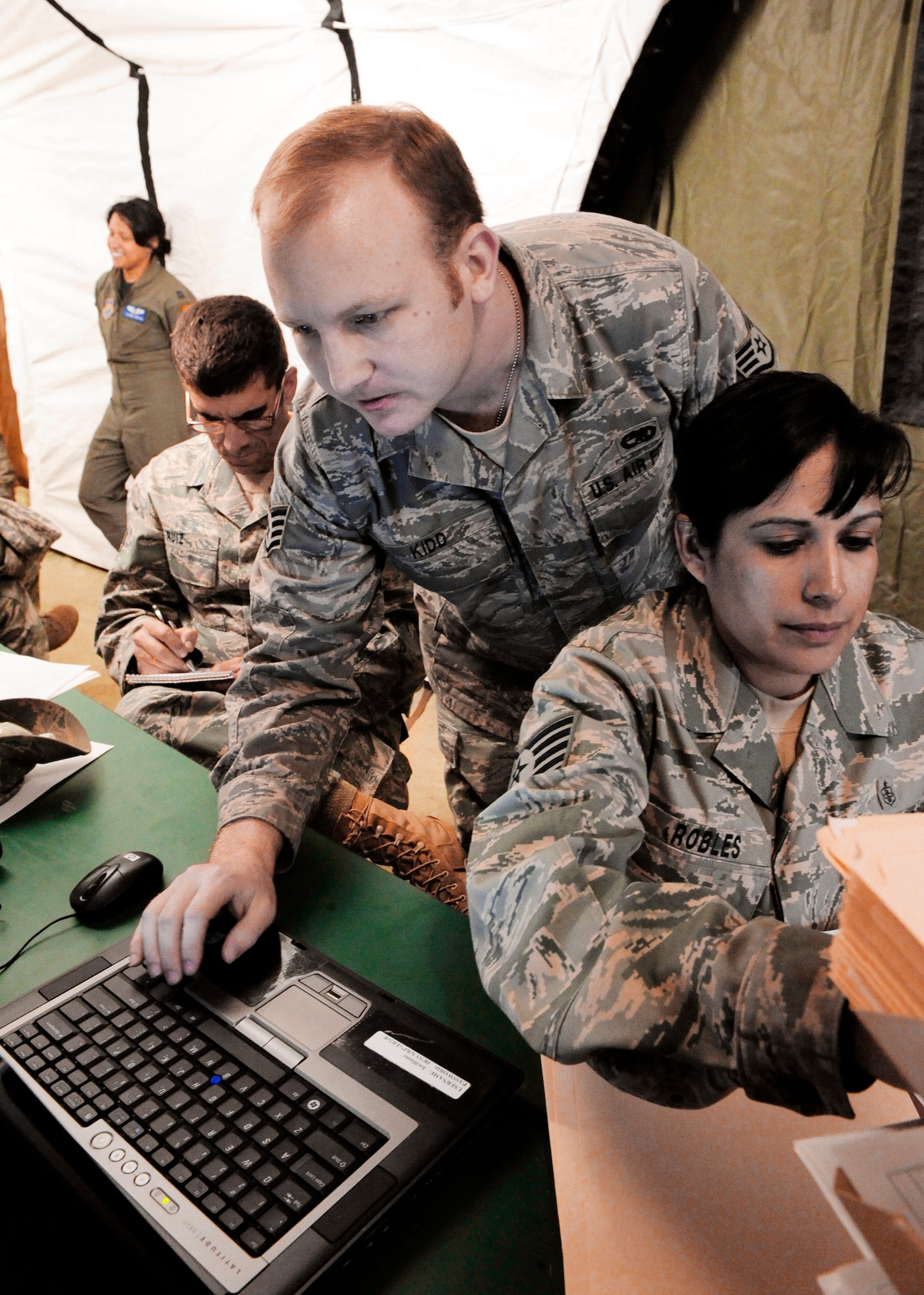 Staff Sgt William Kidd adds a computer to the domain for the Expeditionary Medical Support team admitting desk to the domain March 15, 2010, in Angol, Chile. Sergeant Kidd, assigned to the 52nd Combat Communications Squadron from Robins Air Force Base, Ga., deployed with another member of his unit March 7 to support an Expeditionary Medical Support team in relief efforts after the earthquake in Chile Feb. 27. (U.S. Air Force photo/Senior Airman Tiffany Trojca)