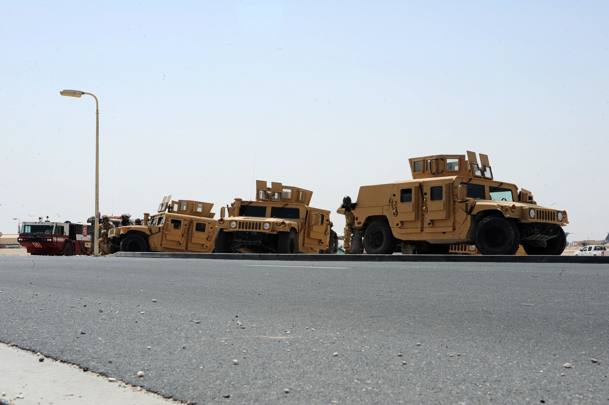 Members of 379th Expeditionary Security Forces Squadron, 379th Expeditionary Civil Engineer Squadron, and host-nation forces stand ready during an exercise scenario at a non-disclosed Southwest Asia location March 23, 2010. (U.S. Air Force photo by Senior Airman Kasey Zickmund)[RELEASED]