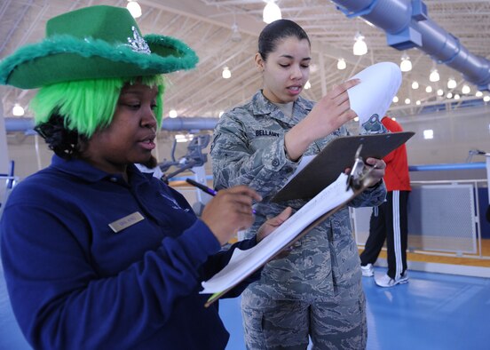 MINOT AIR FORCE BASE, N.D. -- Senior Airman Valerie King, 5th Force Support Squadron fitness specialist, and Airman 1st Class Destiny Bellamy, 741st Missile Squadron chef, look over official run times for the “St. Paddy’s Day relay race” at Minot AFB March 17. Each four-person team was comprised of two males and two females and required each team member to run 1.5 miles. The 5th Civil Engineer Squadron won the event with a combined run time of 40:34. (U.S. Air Force photo by Senior Airman Sharida Jackson)