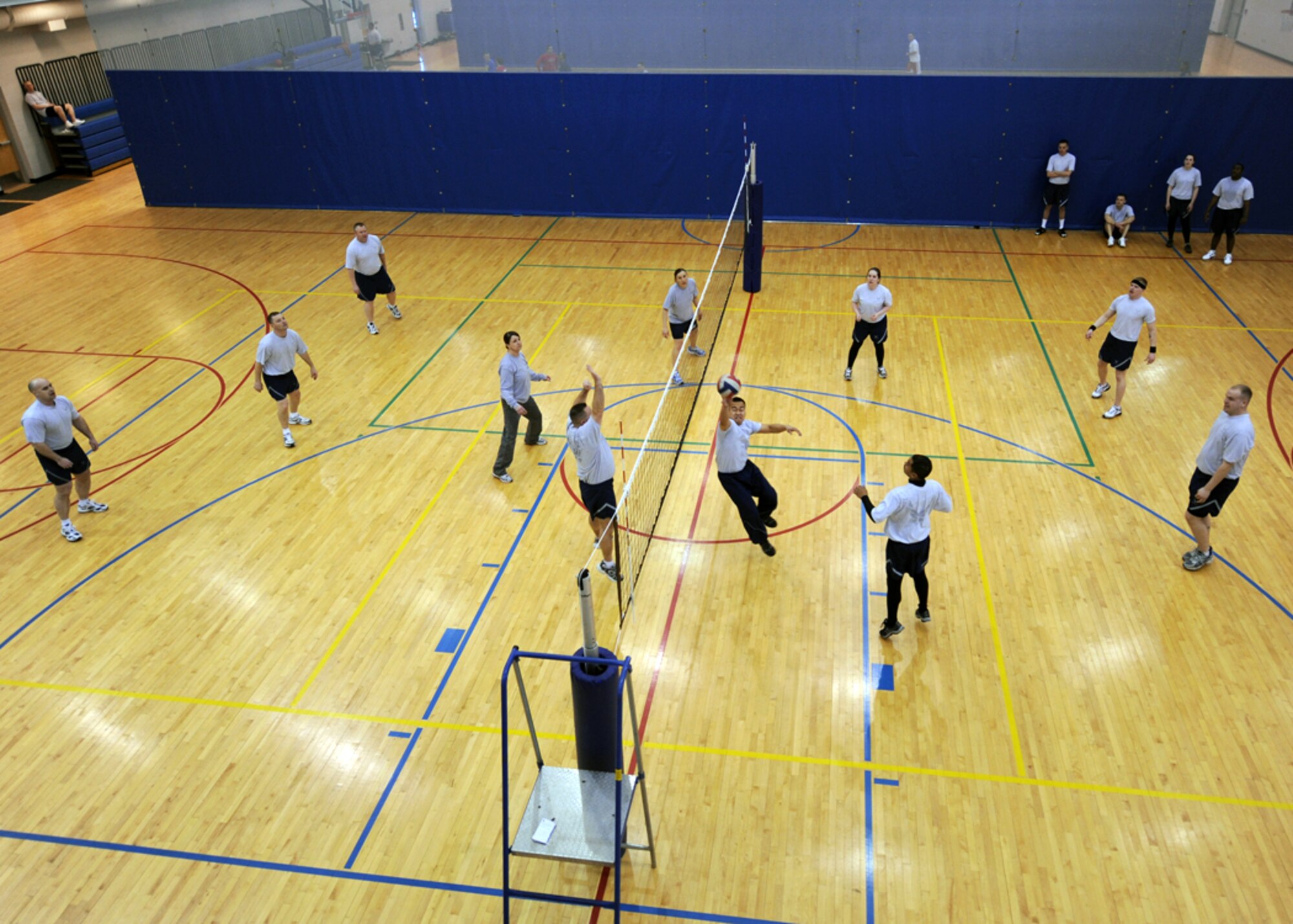MINOT AIR FORCE BASE, N.D. -- Members of the Airman Leadership School class 10-D play a volleyball game against Minot AFB chief master sergeants and first sergeants at the base fitness center March 16. The game is held the day prior to each ALS class graduation and is a best out of three game series. The chiefs and first sergeants swept the ALS students in the series with scores of 21-17, 21-9 and 21-5. (U.S. Air Force photo by Senior Airman Sharida Jackson)