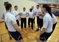 MINOT AIR FORCE BASE, N.D. -- Members of Airman Leadership School class 10-D discuss their game plan prior to starting a volleyball game against the Minot AFB chief master sergeants and first sergeants team at the base fitness center March 16. The volleyball game is held the day prior to each ALS class graduation and is a best out of three game series. The chiefs and first sergeants swept the ALS students in the series with scores of 21-17, 21-9 and 21-5. (U.S. Air Force photo by Senior Airman Sharida Jackson)