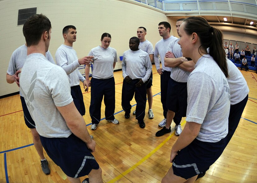 MINOT AIR FORCE BASE, N.D. -- Members of Airman Leadership School class 10-D discuss their game plan prior to starting a volleyball game against the Minot AFB chief master sergeants and first sergeants team at the base fitness center March 16. The volleyball game is held the day prior to each ALS class graduation and is a best out of three game series. The chiefs and first sergeants swept the ALS students in the series with scores of 21-17, 21-9 and 21-5. (U.S. Air Force photo by Senior Airman Sharida Jackson)