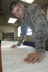 MINOT AIR FORCE BASE, N.D. -- Airman 1st Class Daniel Lindsey, 5th Operations Support Squadron airfield management operations coordinator, performs flight following and planning procedures at base operations March 19. Airfield management crew members manage and maintain all flight line operations in support of the B-52H Stratofortress as well as all 5th Bomb Wing aircrew personnel. (U.S. Air Force photo by Senior Airman Jesse Lopez)