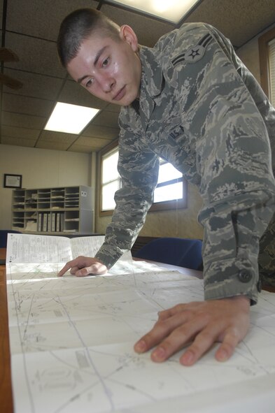 MINOT AIR FORCE BASE, N.D. -- Airman 1st Class Daniel Lindsey, 5th Operations Support Squadron airfield management operations coordinator, performs flight following and planning procedures at base operations March 19. Airfield management crew members manage and maintain all flight line operations in support of the B-52H Stratofortress as well as all 5th Bomb Wing aircrew personnel. (U.S. Air Force photo by Senior Airman Jesse Lopez)