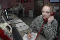 MINOT AIR FORCE BASE, N.D. -- Airman 1st Class Kaysi Craig, 5th Operations Support Squadron airfield management operations coordinator, responds to the primary crash net alert phone at base operations March 19. Airfield management crew members manage and maintain all flight line operations in support of the B-52H Stratofortress as well as all 5th Bomb Wing aircrew personnel. (U.S. Air Force photo by Senior Airman Jesse Lopez)