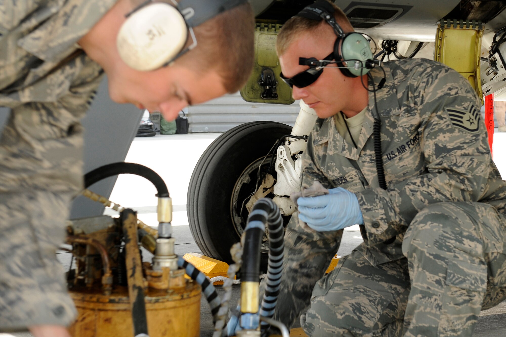 U.S. Air Force Staff Sgt. Lucas Inboden (right) and Senior Airman Anthony Creasey, 34th Expeditionary Fighter Squadron, recover an F-16 at Bagram Airfield, Afghanistan, after the aircraft completed 30 code 1 flights, March 23, 2010. Sergeant Inboden is deployed from Hill Air Force Base, Utah, and is from Dallas, Texas. Airman Creasey is also deployed from Hill AFB and is from Buchannon, W.Va. (U.S. Air Force photo by/ Tech. Sgt. Jeromy K. Cross/released)