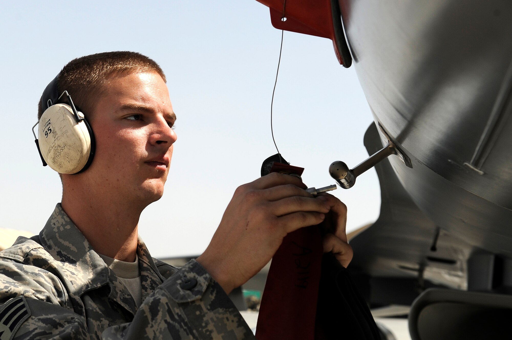 U.S. Air Force Senior Airman Anthony Creasey, 34th Expeditionary Fighter Squadron, recovers an F-16 at Bagram Airfield, Afghanistan, after the aircraft completed 30 code 1 flights, March 23, 2010. Airman Creasey is deployed from Hill Air Force Base, Utah, and is from Buchannon, W.Va. (U.S. Air Force photo by/ Tech. Sgt. Jeromy K. Cross/released)