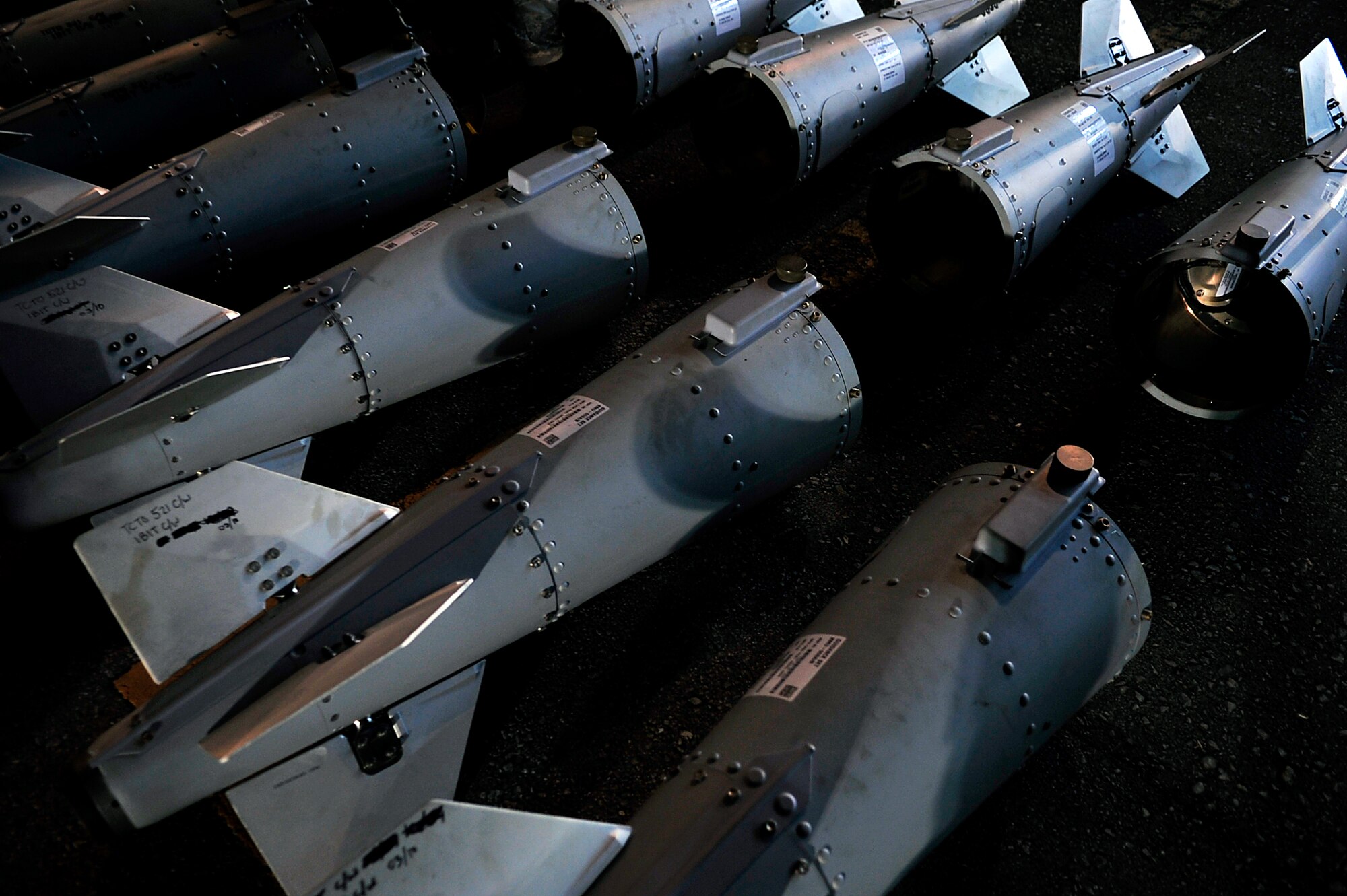 Airmen from the 18th Munitions Squadron attach the tail-ends of Mark 83 bomb bodies during Beverly High 10-02 at Kadena Air Base, Japan, March 24. The 18th Wing is participating in a Local Operational Readiness Exercise March 22-26 to test the readiness of Kadena Airmen. (U.S. Air Force photo/Senior Airman Amanda Grabiec)   