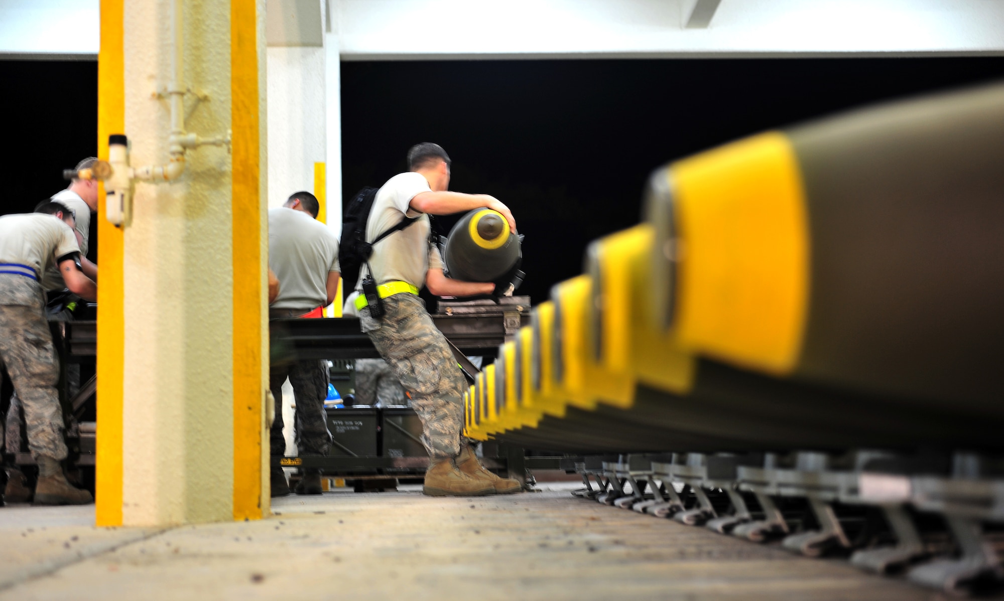 Airmen from the 18th Munitions Squadron  build Mark 83 bomb bodies during Beverly High 10-02 at Kadena Air Base, Japan, March 24. The 18th Wing is participating in a Local Operational Readiness Exercise March 22-26 to test the readiness of Kadena Airmen. (U.S. Air Force photo/Tech. Sgt. Rey Ramon)   