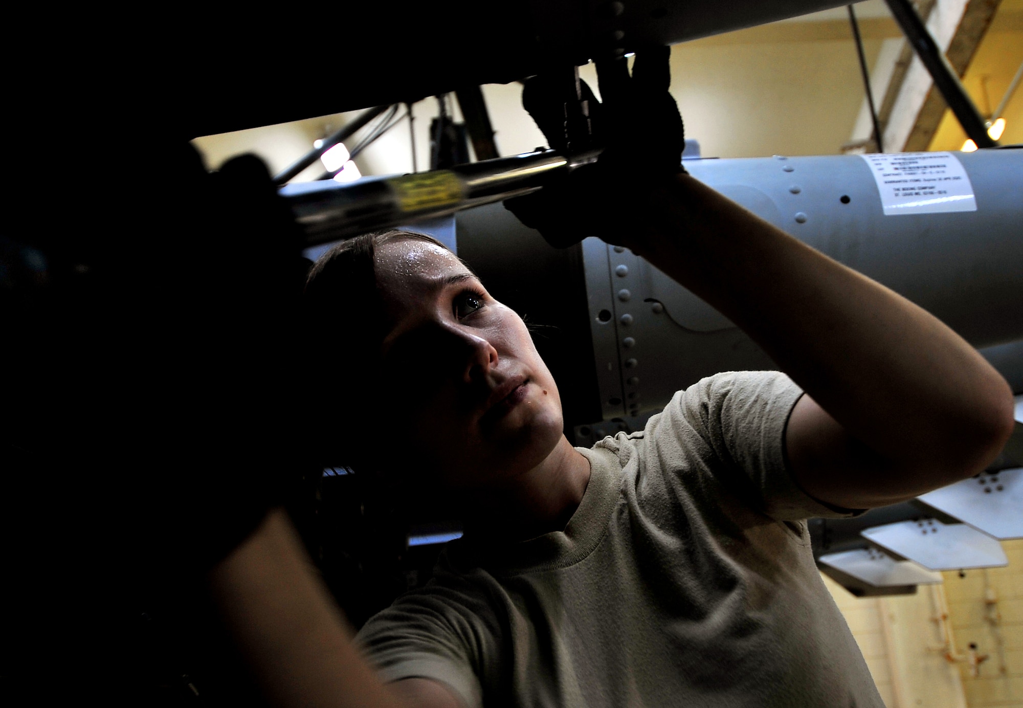 Senior Airman Niki Birch, 18th Munitions Squadron customer support technician, attaches the tail-ends of Mark 83 bomb bodies during Beverly High 10-02 at Kadena Air Base, Japan, March 24. The 18th Wing is participating in a Local Operational Readiness Exercise March 22-26 to test the readiness of Kadena Airmen. (U.S. Air Force photo/Tech. Sgt. Rey Ramon)   