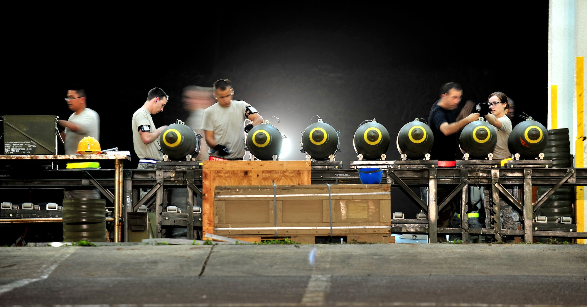 Airmen from the 18th Munitions Squadron build Mark 83 bomb bodies during Beverly High 10-02 at Kadena Air Base, Japan, March 24. The 18th Wing is participating in a Local Operational Readiness Exercise March 22-26 to test the readiness of Kadena Airmen. (U.S. Air Force photo/Tech. Sgt. Rey Ramon)   