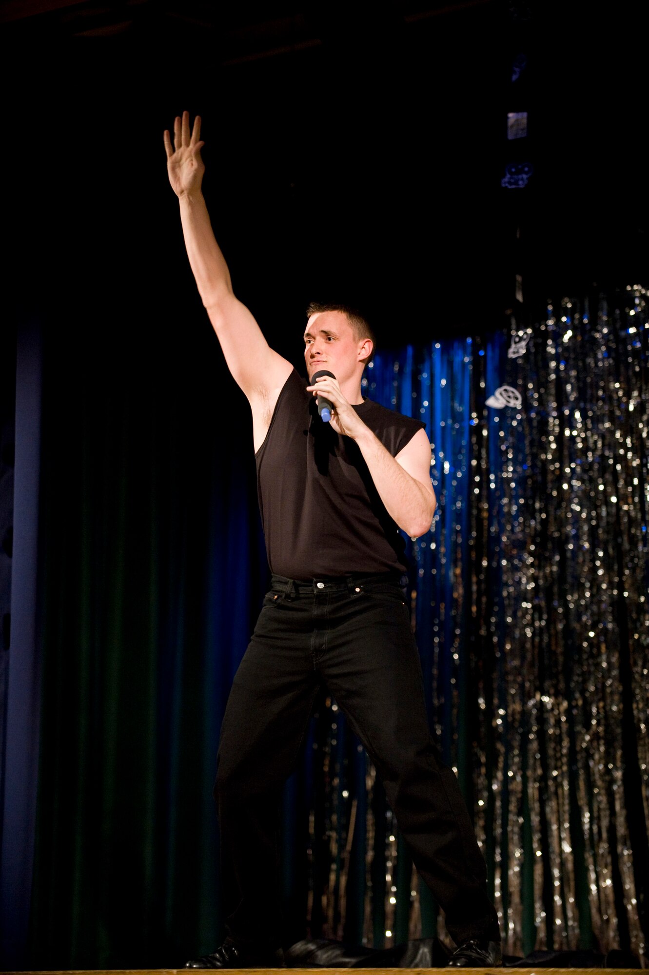 MISAWA AIR BASE, Japan -- Airman 1st Class Cordero Nichols, 301st Intelligence Squadron mission assistance technician, dances while singing "Grease Lightning" during the second round of Misawa Idol at the collocated club March 20. The theme for the second round was television and movie music. This was the second of four elimination rounds before the finale scheduled April 24. (U.S. Air Force photo/Staff Sgt. Samuel Morse)