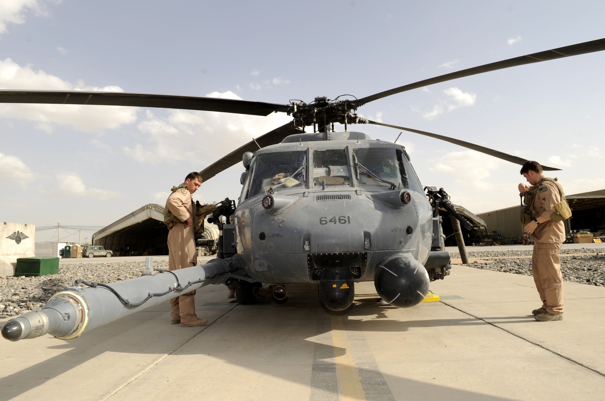 Capt. Josh Irvine and Capt. Rob Roth, 66th Expeditionary Rescue Squadron, conduct a routine preflight check on a HH-60G Pave Hawk helicopter March 5.  Captain Irvine is the crews aircraft commander and Captain Roth is the mission pilot assigned to Nellis AFB, NV.  (U.S. Air Force photos by Senior Airman Nancy Hooks/Released)
