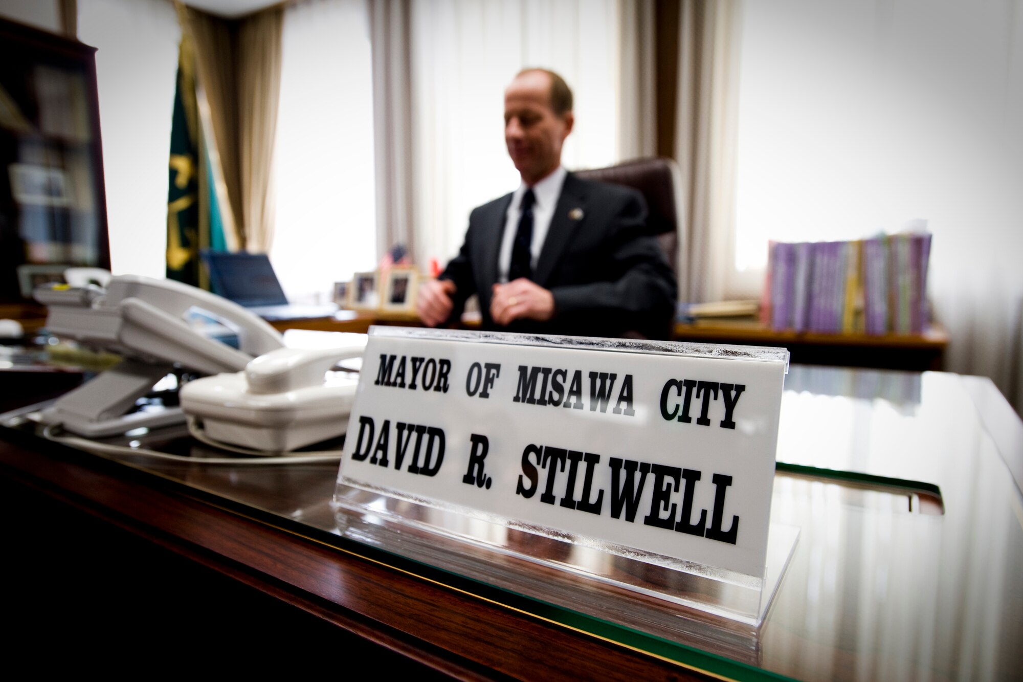 MISAWA CITY, Japan -- Col. David Stilwell, 35th Fighter Wing commander and honorary Mayor of Misawa City, sits in the mayor's chair March 23 during the Misawa Mayor for a Day event. As the honorary mayor, Colonel Stilwell reviewed and approved a staff report, toured the departments of Misawa City Hall and attended a senior-staff meeting with officials from the city. (U.S. Air Force photo/Senior Airman Jamal D. Sutter)