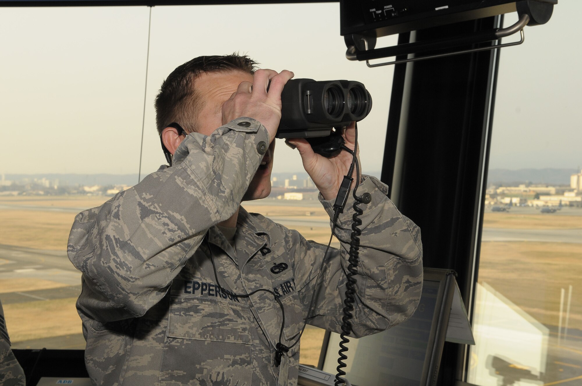 YOKOTA AIR BASE, Japan -- Tech. Sgt. Eric Epperson, 374th Operations Support Squadron assistant chief controller, looks for inbound aircraft March 20 during the Kanto Plain Mid-Air Collision Avoidance Conference. The MACA conference brought together military and civilian pilots from all over Japan to focus on flight safety and base flight procedures. (U.S. Air Force photo/Airman 1st Class Sean Martin)