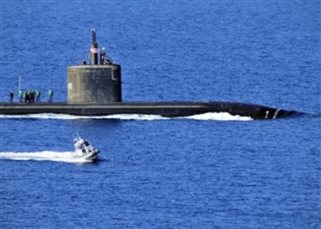 A harbor security boat escorts the attack submarine USS Annapolis (SSN 760).