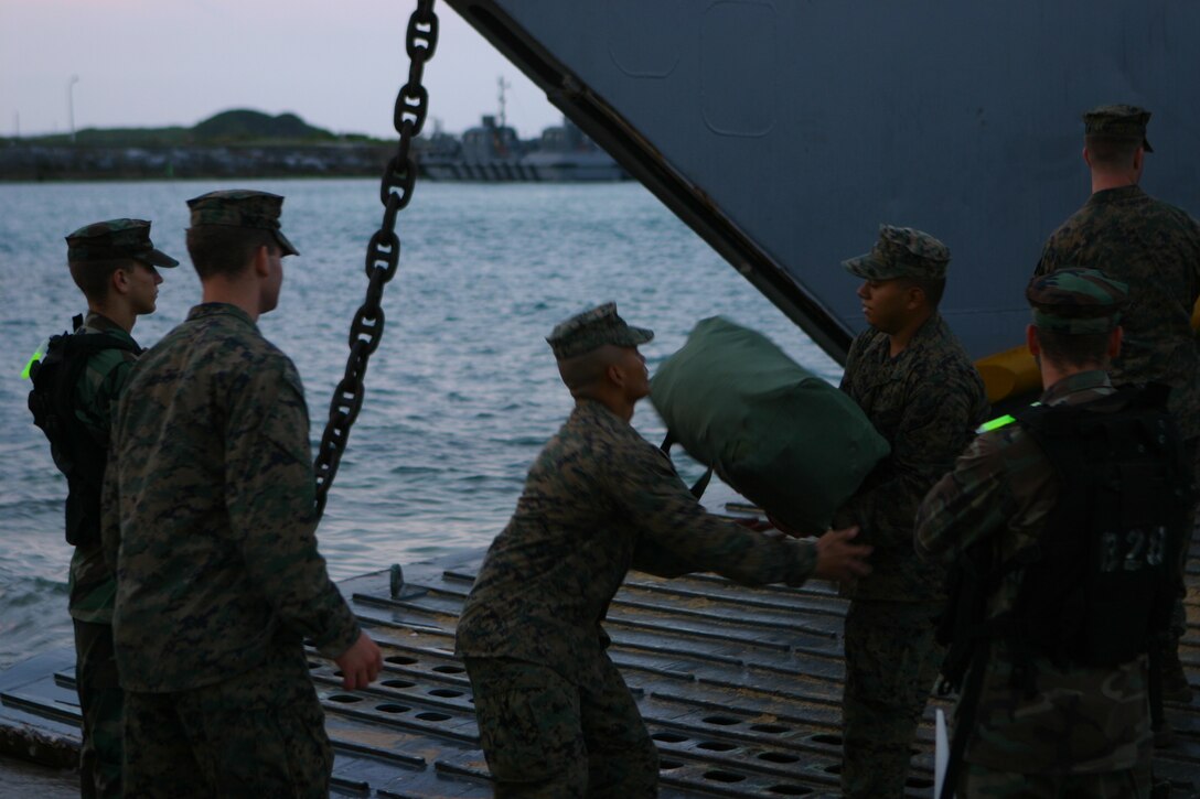 Marines with Battalion Landing Team 2nd Battalion, 7th Marines (BLT 2/7), 31st Marine Expeditionary Unit (MEU), disembark gear from a landing craft unit (LCU), March 25. The MEU has recently returned from its spring patrol of the Asia –Pacific  region. (Official Marine Corps photo by Cpl. Michael A. Bianco)