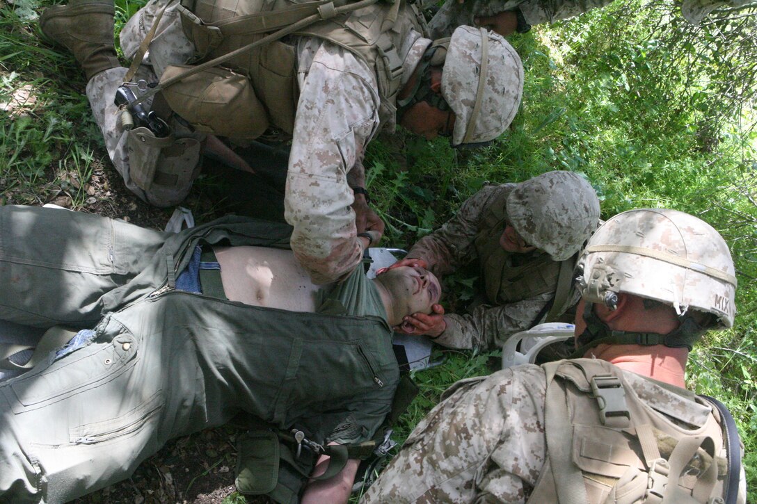Marines and sailors with 1st Battalion, 7th Marine Regiment, provide simulated medical attention to a pilot at Marine Corps Base Camp Pendleton’s K2 Military Operations in Urban Terrain facility during a Tactical Recovery of Aircraft and Personnel exercise March 25. TRAP teams are trained to provide medical care, and simultaneously search for sensitive equipment and materials in a variety of scenarios.