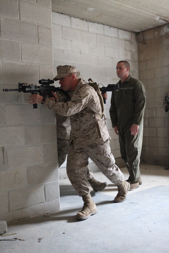Marines with Battalion Landing Team 3/8, Light Armor Reconnaissance (LAR) platoon, practice clearing a building at the Military Operations in Urban Training (MOUT) facility aboard Ft. Pickett, Va., March 25. 2010. The  26th MEU, which consists of Battalion Landing Team 3/8, Combat Logistics Battalion 26, and Marine Medium Tiltrotor Squadron 266, will spend the next six months training for its upcoming deployment. (Official United States Marine Corps Photo by Cpl. Jesse J. Johnson) (Released)::r::::n::