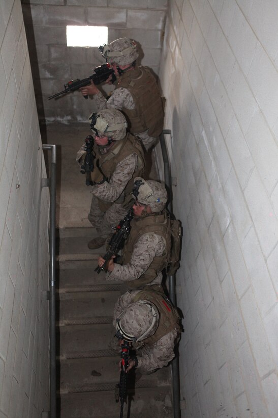 Marines with the Battalion Landing Team 3/8, Weapons Company, practice clearing buildings at the Military Operations in Urban Training (MOUT) facility aboard Ft. Pickett, Va., March 25, 2010. The 26th MEU, which consists of Battalion Landing Team 3/8, Combat Logistics Battalion 26, and Marine Medium Tiltrotor Squadron 266, will spend the next six months training for its upcoming deployment. (Official United States Marine Corps Photo by Cpl. Jesse J. Johnson) (Released)::r::::n::
