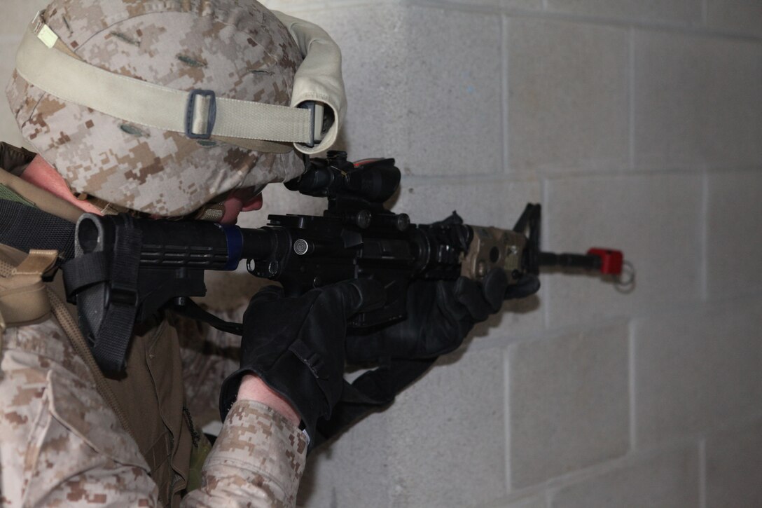 Marines with Battalion Landing Team 3/8, Weapons Company, practice clearing buildings at the Military Operations in Urban Training (MOUT) facility aboard Ft. Pickett, Va., March 25, 2010. The 26th MEU, which consists of Battalion Landing Team 3/8, Combat Logistics Battalion 26, and Marine Medium Tiltrotor Squadron 266, will spend the next six months training for its upcoming deployment. (Official United States Marine Corps Photo by Cpl. Jesse J. Johnson) (Released)::r::::n::::r::::n::