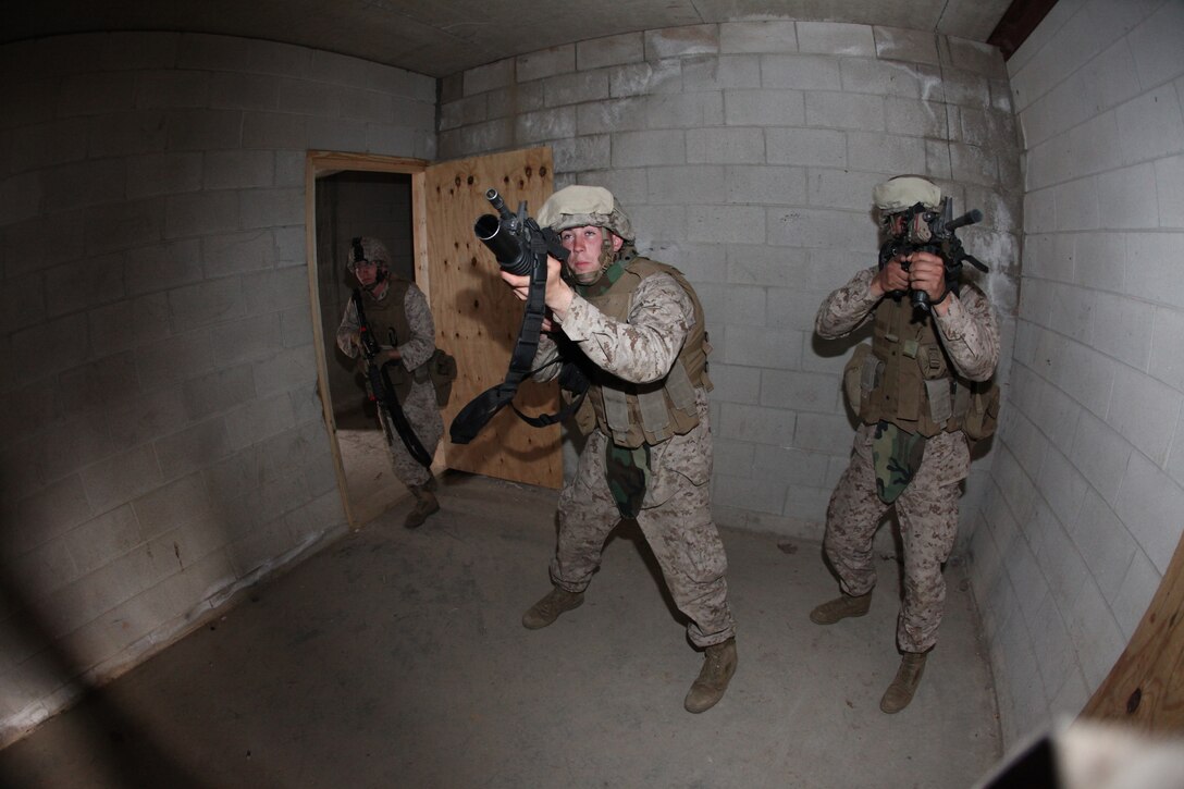 Marines with Battalion Landing Team 3/8, Weapons Company, practice clearing buildings at the Military Operations in Urban Training (MOUT) facility aboard Ft. Pickett, Va., March 25, 2010. The 26th MEU, which consists of Battalion Landing Team 3/8, Combat Logistics Battalion 26, and Marine Medium Tiltrotor Squadron 266, will spend the next six months training for its upcoming deployment. (Official United States Marine Corps Photo by Cpl. Jesse J. Johnson) (Released)::r::::n::::r::::n::