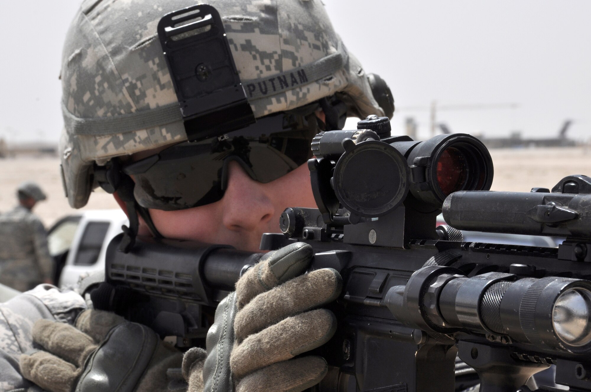 Staff Sgt. Travis Putnam, a 379th Expeditionary Forces Squadron member, stands ready March 23, 2010, during an exercise at an air base in Southwest Asia. (U.S. Air Force photo/Capt. Patrick Cordova)