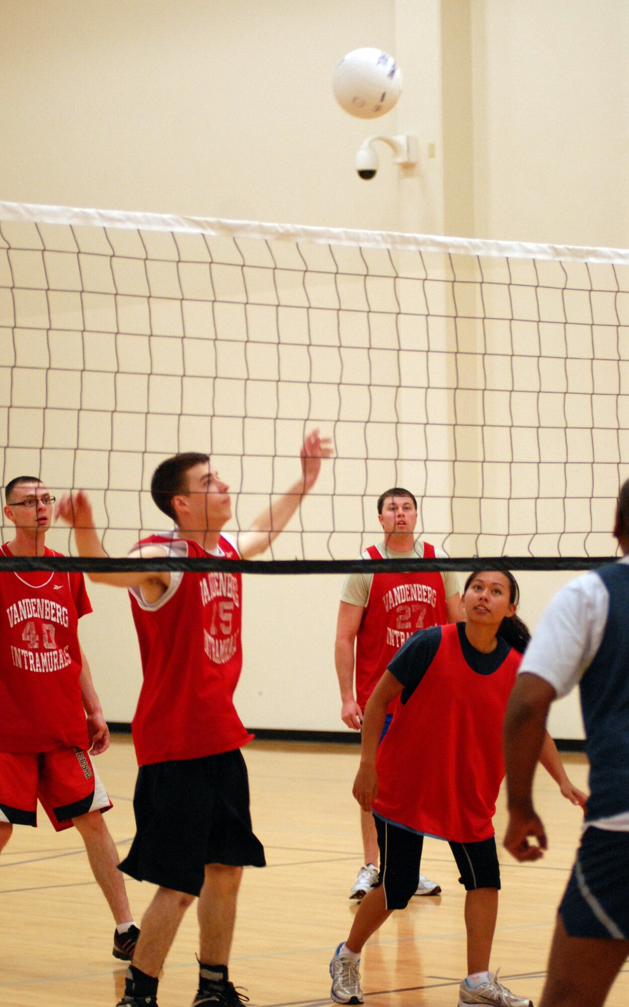 VANDENBERG AIR FORCE BASE, Calif. - - Members of the 30th Space Communications Squadron team prepare as Justin Holtz sets the ball over the net during an intramural volleyball game here Wednesday, March 24, 2010. The 30th Space Wing Staff Agencies team won the game 2-1 against 30th SCS team. (U.S. Air Force photo/Airman 1st Class Angelina Drake)