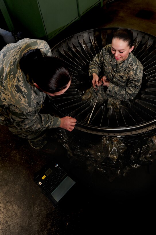 ELLSWORTH AIR FORCE BASE, S.D. -- (Left to right) Senior Airmen Erica Plymale and Angelique Hasz, 28th Maintenance Squadron aerospace propulsion journeymen, tighten bolts on a B-1B Lancer engine part, March 11. The theme of the 2010 National Women's History Month is "Writing Women Back Into History," which is honored in the Air Force by remembering such historic dates as: July 8, 1948 - when Esther Blake became the first woman to enlist in the Air Force. (U.S. Air Force photo/Airman 1st Class Joshua J. Seybert)