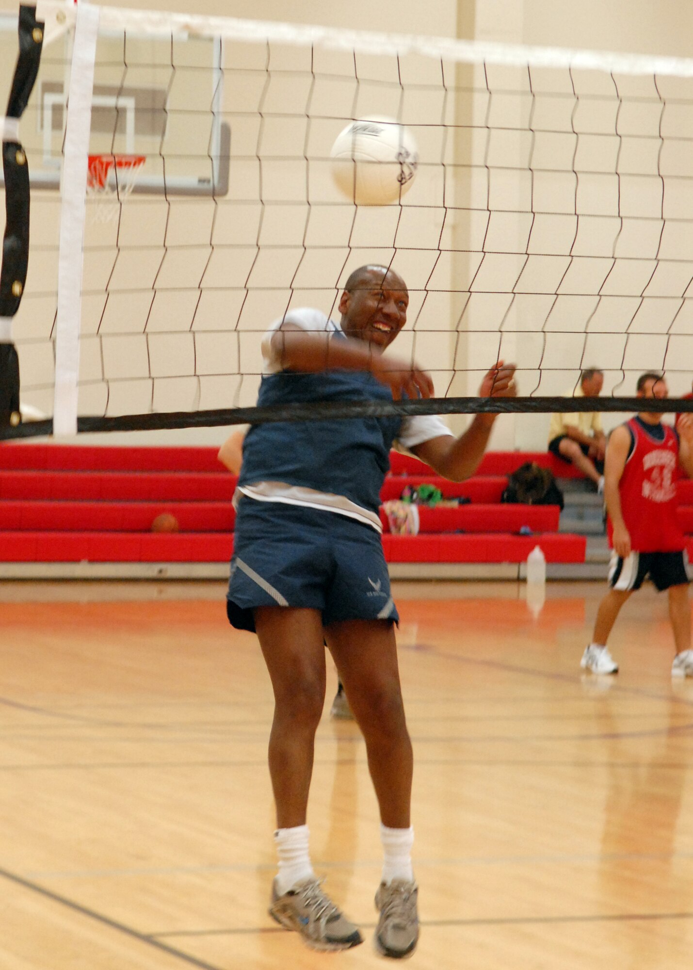 VANDENBERG AIR FORCE BASE, Calif. -- Preparing for the game, Warren Watties, a member of the 30th Space Wing Staff Agencies team, practices his spiking with the assistance of another teammate here Wednesday, March 24, 2010. During an intramural volleyball game, the 30th SW Staff Agencies team won 2-1 against the 30th Space Communications Squadron team. (U.S. Air Force photo/Airman 1st Class Angelina Drake)