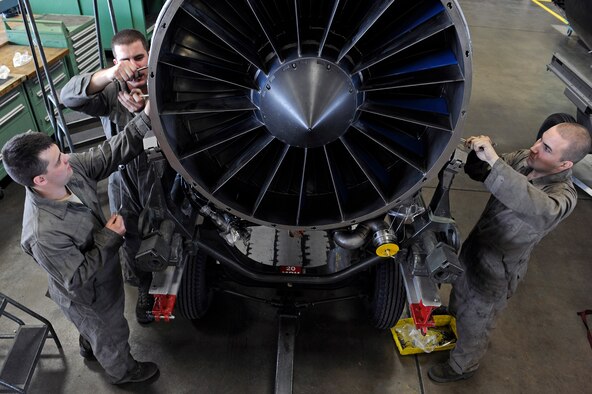 ELLSWORTH AIR FORCE BASE, S.D. – (From left) Airmen 1st Class Jesse Davis, Benjamen Lundy and Jonathan Bettenhausen, 28th Maintenance Squadron aerospace propulsion technicians, tighten bolts on a B-1B Lancer engine, March 25.  The B-1 engines are inspected after every 100 hours of flying. (U.S. Air Force photo/Senior Airman Marc I. Lane)