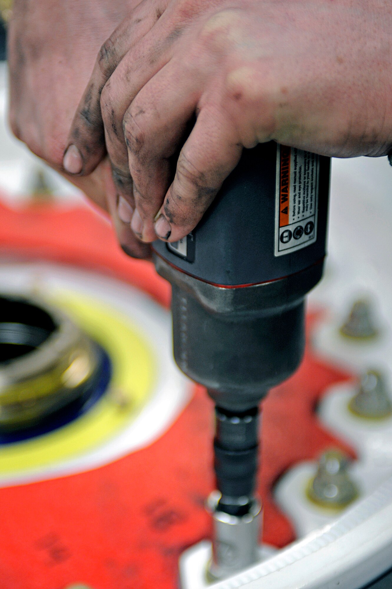 ELLSWORTH AIR FORCE BASE, S.D. -- Airman 1st Class Max Nelson, 28th Maintenance Squadron repair and reclamation apprentice, uses a torque wrench to tighten bolts on a tire, March 24. On average, it takes about 40 minutes to completely tear down and rebuild a tire. (U.S. Air Force photo/Airman 1st Class Matthew Flynn)