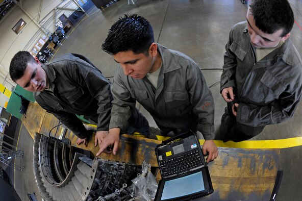 ELLSWORTH AIR FORCE BASE, S.D. – (Center) Staff Sgt. Ricardo Gonzales demonstrates how to inspect honey comb seals on the front compressor of a B-1B Lancer engine to Airmen 1st Class Steven Durr and Jesse Davis (right), March 25.  All three Airmen are aerospace propulsion technicians assigned to the 28th Maintenance Squadron. (U.S. Air Force photo/Senior Airman Marc I. Lane)