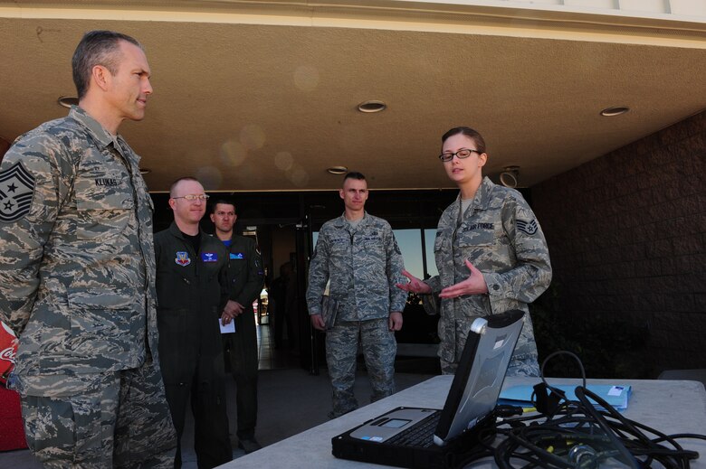 CREECH AIR FORCE BASE, Nev. -- Staff Sgt. Karen Fogg, 11th Reconnaissance Squadron operations intelligence journeyman, shows Chief Master Sgt. Martin Klukas, command chief of Air Combat Command, how the Remotely Operated Video Enhanced Receiver, or ROVER, is able to transmit video data from aircraft to joint terminal aircraft controllers on the ground. The March 5 visit was his first to Creech AFB since becoming the command chief of ACC. (U.S. Air Force Photo by Staff Sgt. William P. Coleman)
