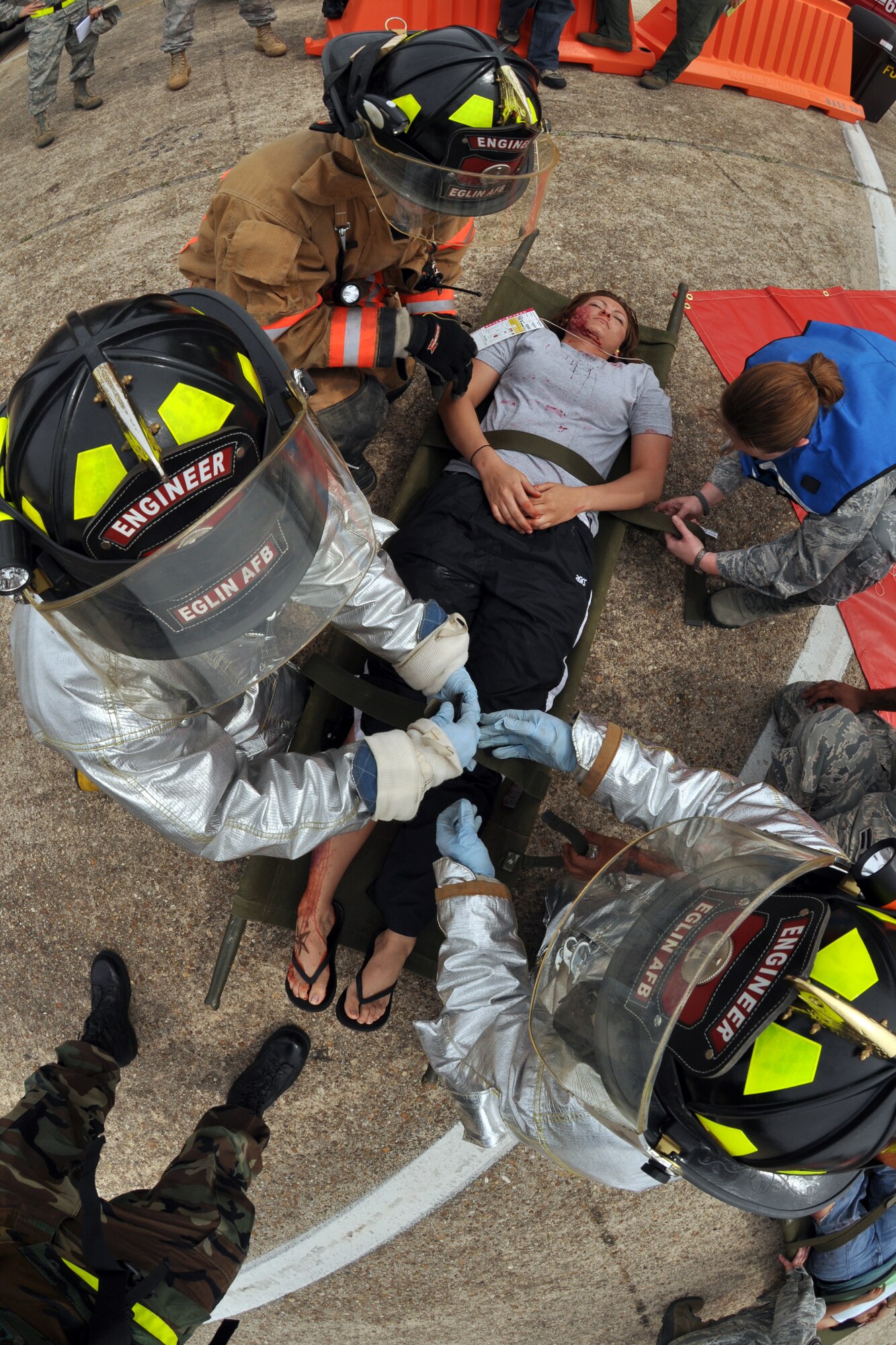 EGLIN AIR FORCE BASE, Fla. – 96th Medical Group personnel and 96th Civil Engineer Group firefighters triage and treat simulated victims during a Major Accident Response Exercise here, March 24. Twenty-four volunteers wore moulage to simulate injuries and enable medical personnel to better train for real-world scenarios. The event simulated an aircraft crash scenario to test how quickly Eglin’s first responders could react to a catastrophe and effectively treat victims. (U.S. Air Force photo/ Airman 1st Class Anthony Jennings)