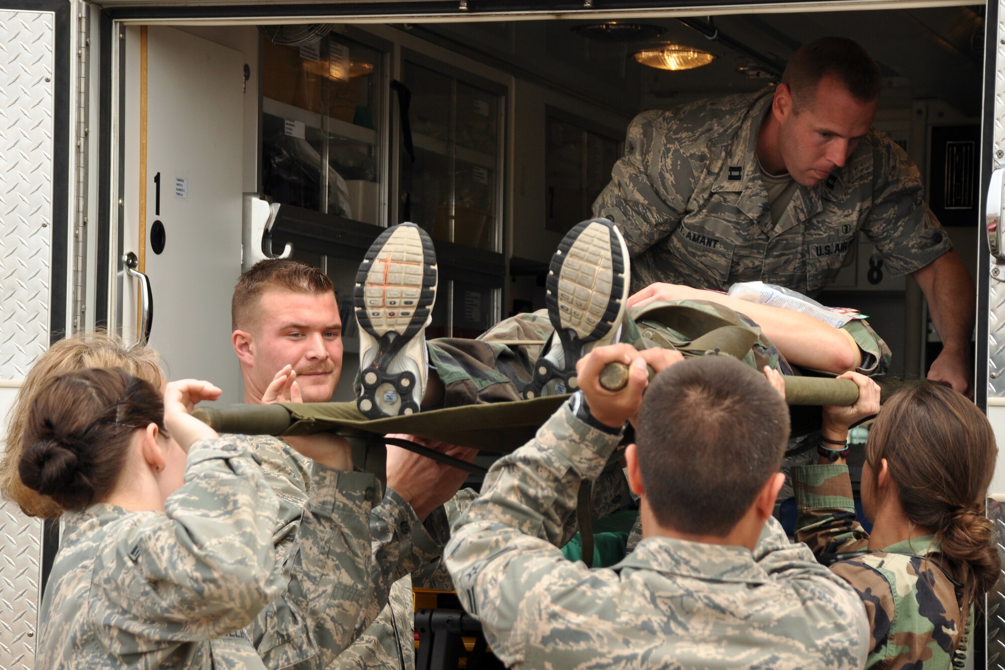 EGLIN AIR FORCE BASE, Fla. --  96th Medical Group personnel lift a simulated victim into an ambulance for treatment during a Major Accident Response Exercise here, March 24. Twenty-four volunteers wore moulage to simulate injuries and enable medical personnel to better train for real-world scenarios. The event simulated an aircraft crash to test how quickly Eglin’s first responders could react to a catastrophe and effectively treat victims. (U.S. Air Force photo/ Airman 1st Class Anthony Jennings)