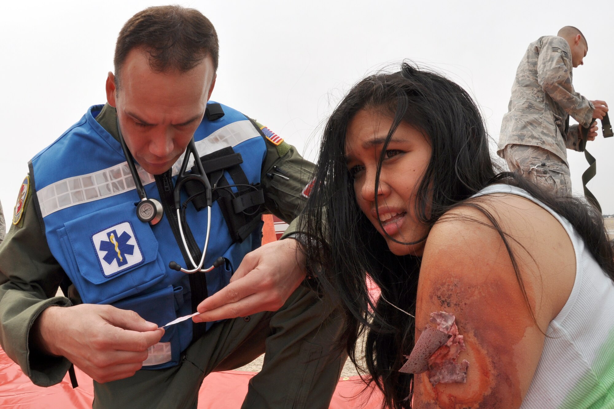 EGLIN AIR FORCE BASE, Fla. --   A simulated victim gets treatment for a shrapnel injury during a Major Accident Response Exercise here, March 24. Twenty-four volunteers wore moulage to simulate injuries and enable medical personnel to better train for real-world scenarios. The event simulated an aircraft crash to test how quickly Eglin’s first responders could react to a catastrophe and effectively treat victims. (U.S. Air Force photo/ Airman 1st Class Anthony Jennings)