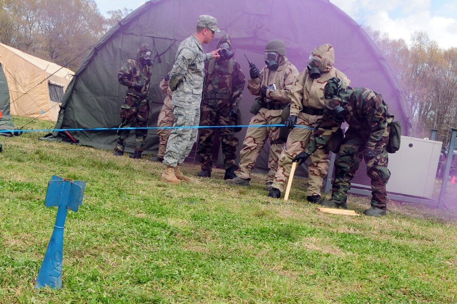 BARKSDALE AIR FORCE BASE, La. --Participants in an Ability to Survive and Operate rodeo block off an unexploded ordnance under the guidance of Senior Airman James McGarvey, 2d Civil Engineer Squadron March 24. The ATSO rodeo was held to prepare Airmen for a phase-two Conventional Operational Readiness Exercise. (U.S. Air Force photo by Senior Airman Joanna M. Kresge)