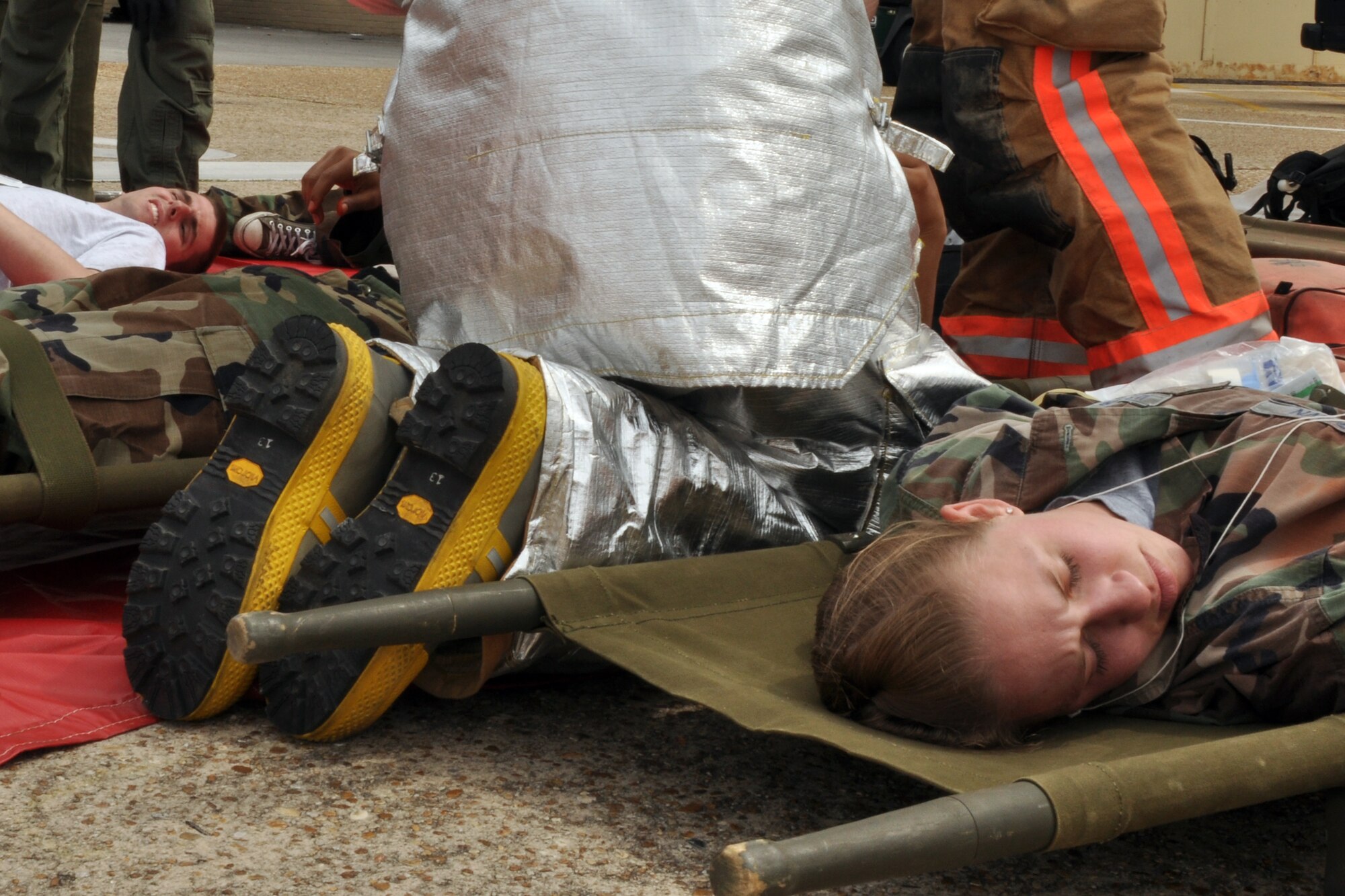EGLIN AIR FORCE BASE, Fla. –  Simulated victims lay on stretchers while 96th Civil Engineer Group firefighters and 96th Medical Group personnel treat their injuries during a Major Accident Response Exercise here, March 24. Twenty-four volunteers wore moulage to simulate injuries and enable medical personnel to better train for real-world scenarios. The event simulated an aircraft crash to test how quickly Eglin’s first responders could react to a catastrophe and effectively treat victims. (U.S. Air Force photo/ Airman 1st Class Anthony Jennings) 
