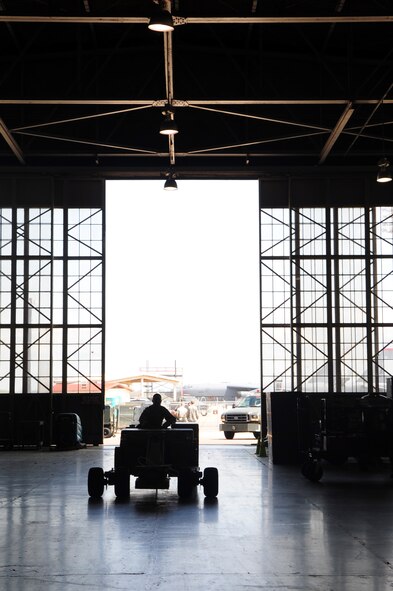 BARKSDALE AIR FORCE BASE, La. -- Airman 1st Class Omar Khadam, 2d Maintenance Squadron aerospace ground equipment mechanic, drives a MHU bomb lift into the AGE hanger for repair March 24. (U.S. Air Force photo by Senior Airman Joanna M. Kresge)