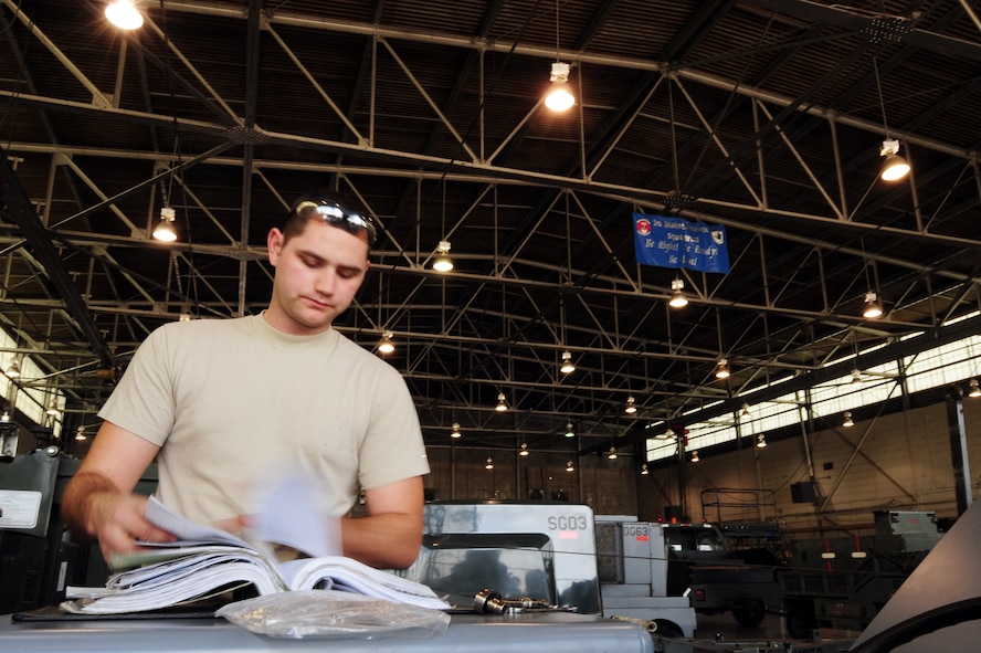 BARKSDALE AIR FORCE BASE, La. -- Senior Airman Matthew Reinke, 2d Maintenance Squadron aerospace ground equipment mechanic searches for a diagram of a MHU bomb lift in a technical order at the AGE hangar March 24. (U.S. Air Force photo by Senior Airman Joanna M. Kresge)