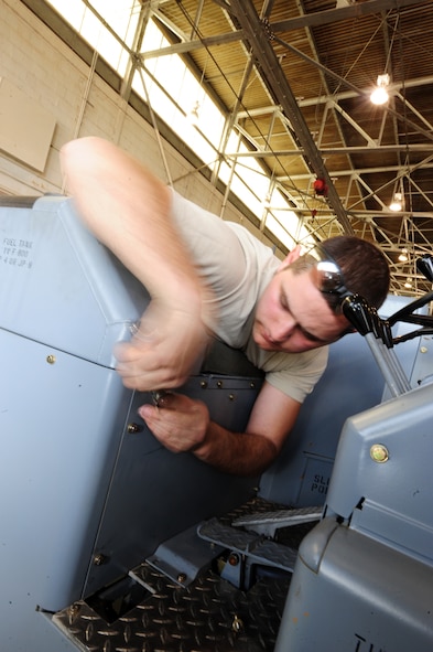 BARKSDALE AIR FORCE BASE, La. -- Senior Airman Matthew Reinke, 2d Maintenance Squadron aerospace ground equipment mechanic, loosens bolts on a panel of a MHU bomb lift at the AGE hangar March 24. (U.S. Air Force photo by Senior Airman Joanna M. Kresge)