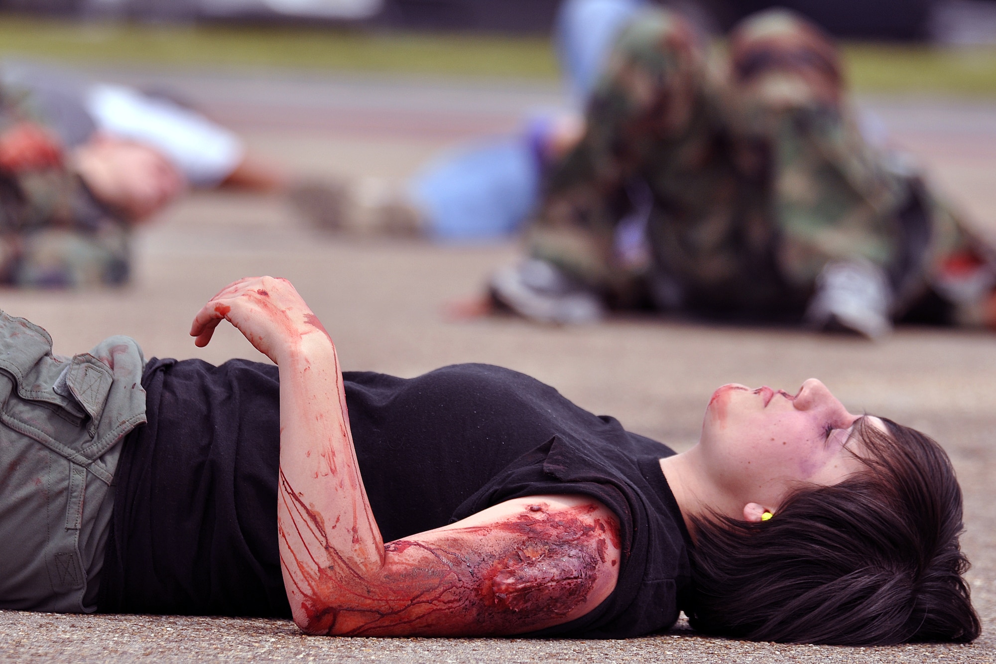 EGLIN AIR FORCE BASE, Fla. –  “Victims” lay injured on Eglin’s flight lines during a Major Accident Response Exercise, March 24. Twenty-four volunteers wore moulage to simulate injuries and enable medical personnel to better train for real-world scenarios. The event simulated an aircraft crash to test how quickly Eglin’s first responders could react to a catastrophe and effectively treat victims. (U.S. Air Force photo/ Airman 1st Class Anthony Jennings)