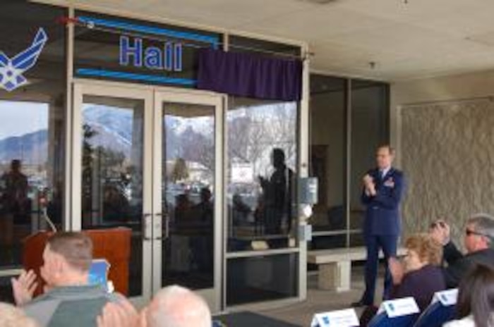 Gen. Cooper applauds after unveiling Building 849's new name, "Price Hall."