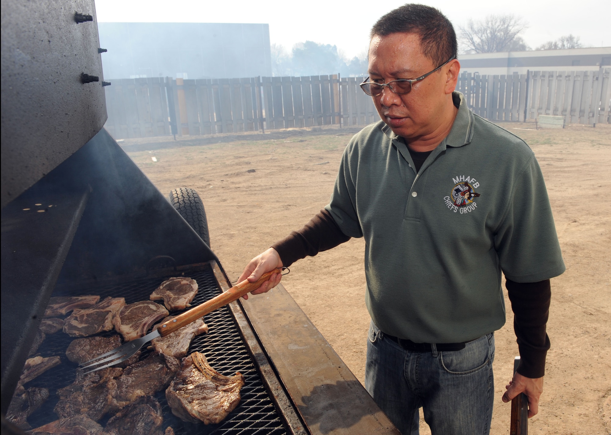MOUNTAIN HOME AIR FORCE BASE, Idaho – Republic of Singapore Chief Master Sgt. Alfred Chow, 428th Fighter Squadron group enlisted manager, grills steaks at the community center during the Chief’s Steak Burn March 17. Money raised from the steak burn helps offset costs of quarterly and annual awards. (U.S. Air Force photo by Airman 1st Class Debbie Lockhart)