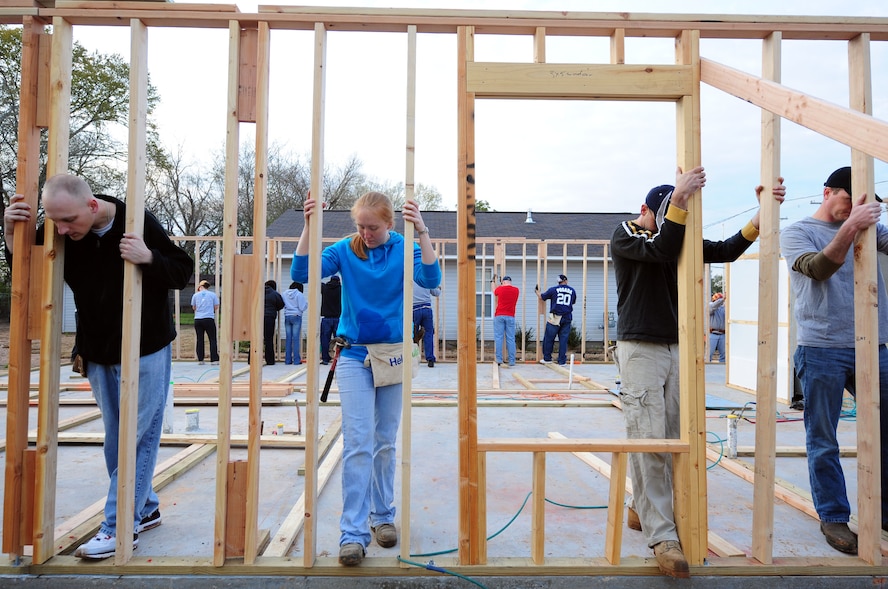 SHREVEPORT, La. – Airmen from the 2d Civil Engineer Squadron at Barksdale Air Force Base hold an exterior wall in place so it can be secured during the first day of construction on a Habitat for Humanity home March 20. The home is being constructed for the Harts, a family from New Orleans who relocated to Shreveport following Hurricane Katrina. (U.S. Air Force photo by Senior Airman Joanna M. Kresge)