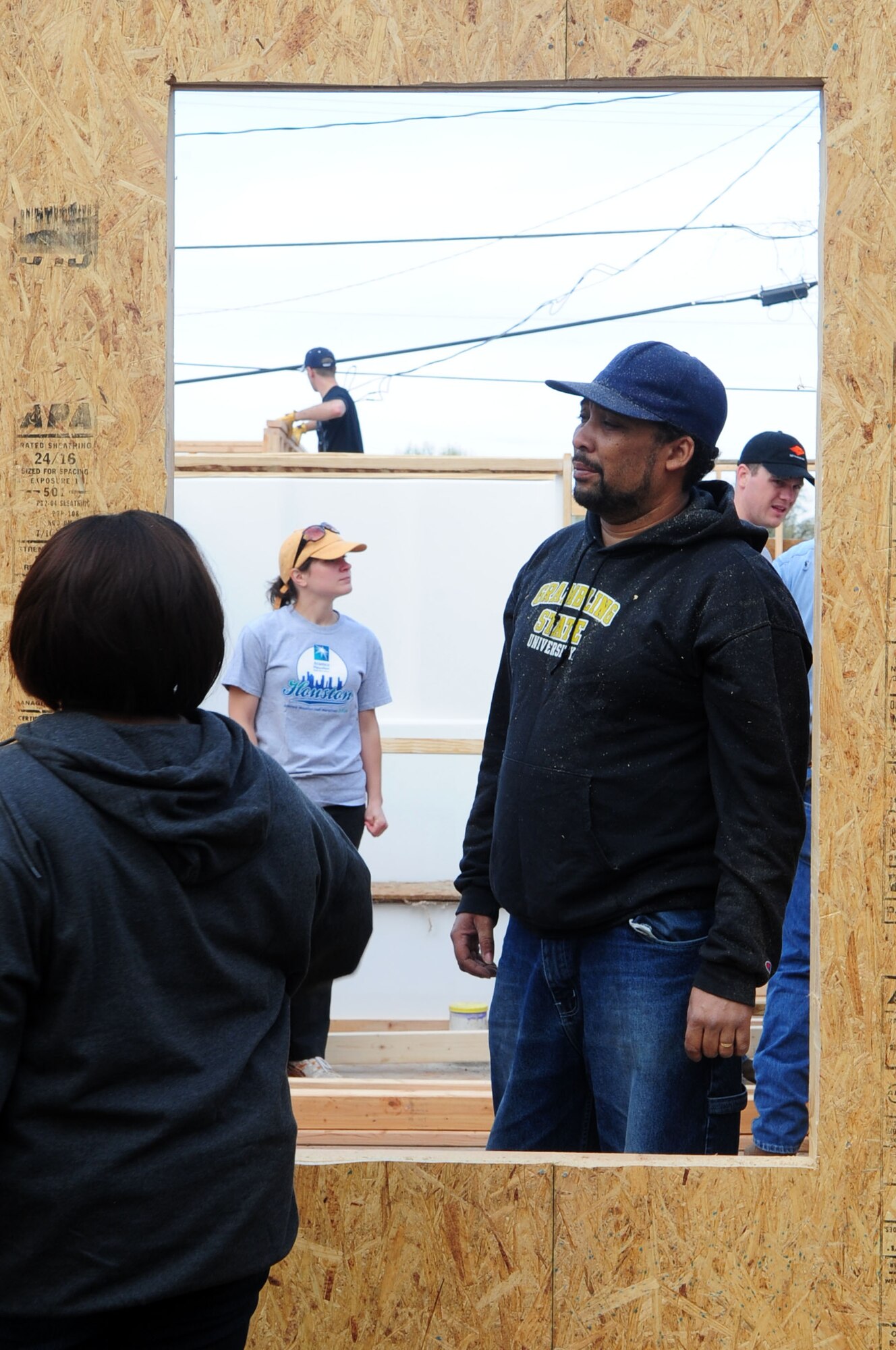SHREVEPORT, La. – Future homeowners, Ralph and Michelle Hart admire their work after cutting out a window in their home March 20. The Hart family was chosen to be recipients of a Habitat for Humanity house after leaving New Orleans following Hurricane Katrina. On the first day of construction, more than 20 Barksdale Air Force Base Airmen turned out along with members of the local community, to help the Hart family build their home. (U.S. Air Force photo by Senior Airman Joanna M. Kresge)