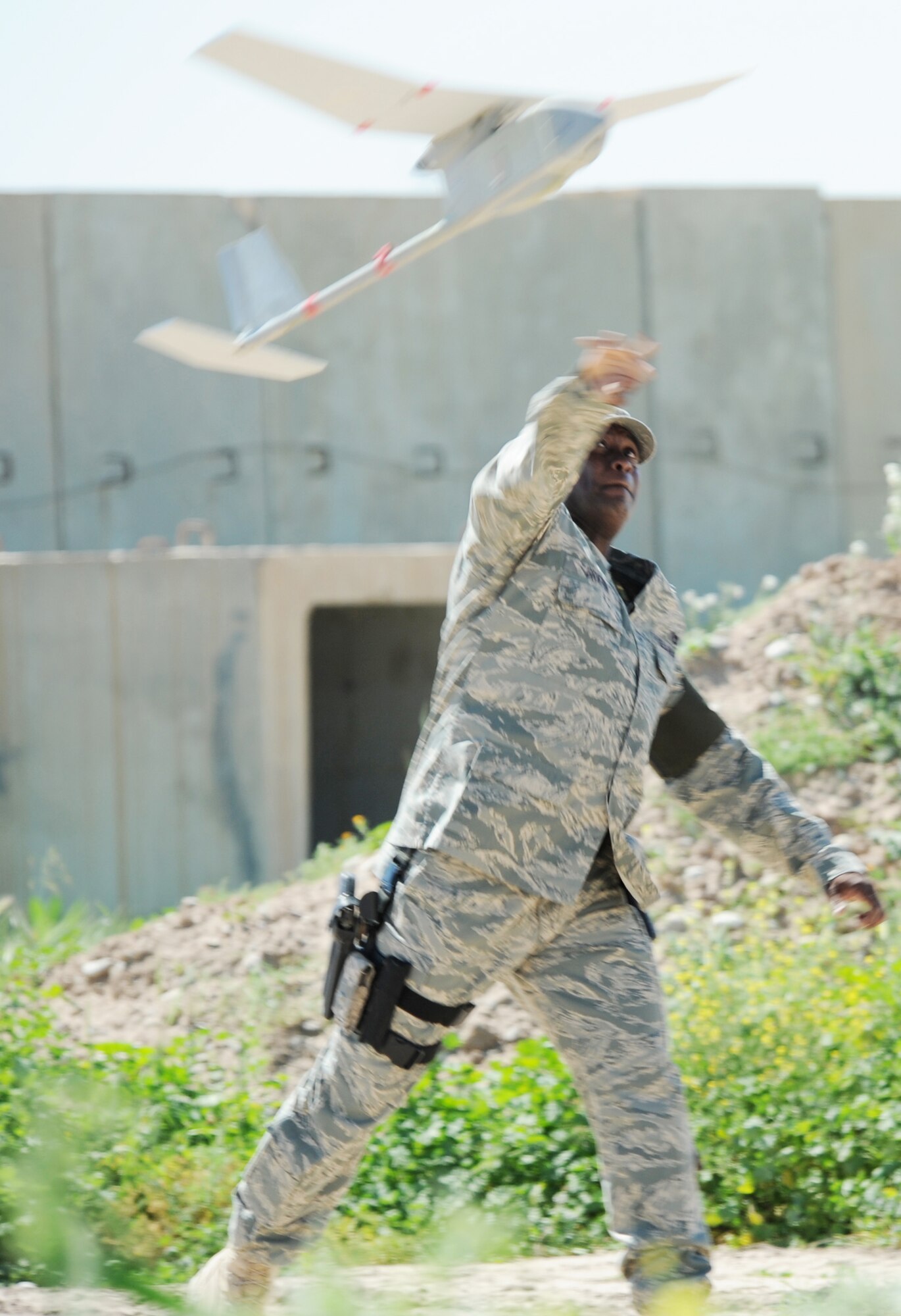 Master Sgt. Bryon Griffin launches a RQ-11B Raven unmanned aerial vehicle at Kirkuk Regional Air Base, Iraq, March 23, 2010. The Raven is equipped with cameras, sensors and communications tools to perform missions in reconnaissance, surveillance, positive target identification and battle damage assessment inside and outside the wire. Sergeant Griffin is the NCOIC with the 506th Expeditionary Security Forces Raven team and deployed from Patrick Air Force Base, Fla. (U.S. Air Force photo/Staff Sgt. Tabitha Kuykendall)