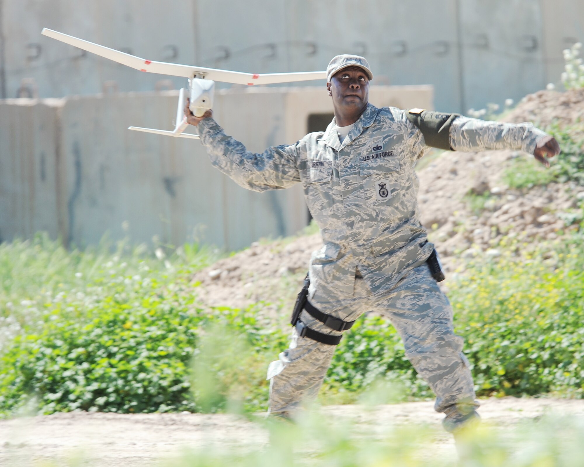 Master Sgt. Bryon Griffin launches a RQ-11B Raven unmanned aerial vehicle at Kirkuk Regional Air Base, Iraq, March 23, 2010. The Raven is equipped with cameras, sensors and communications tools to perform missions in reconnaissance, surveillance, target identification and battle damage assessment inside and outside the wire. Sergeant Griffin is the NCOIC of the 506th Expeditionary Security Forces Raven team and deployed from Patrick Air Force Base, Fla. (U.S. Air Force photo/Staff Sgt. Tabitha Kuykendall)